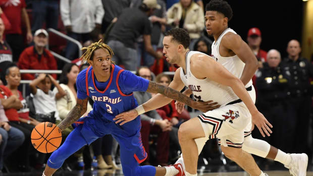 Dec 10, 2021; Louisville, Kentucky, USA; DePaul Blue Demons guard Jalen Terry (3) dribbles against Louisville Cardinals guard Jarrod West (13) during the second half at KFC Yum! Center. DePaul defeated Louisville 62-55. Mandatory Credit: Jamie Rhodes-USA TODAY Sports